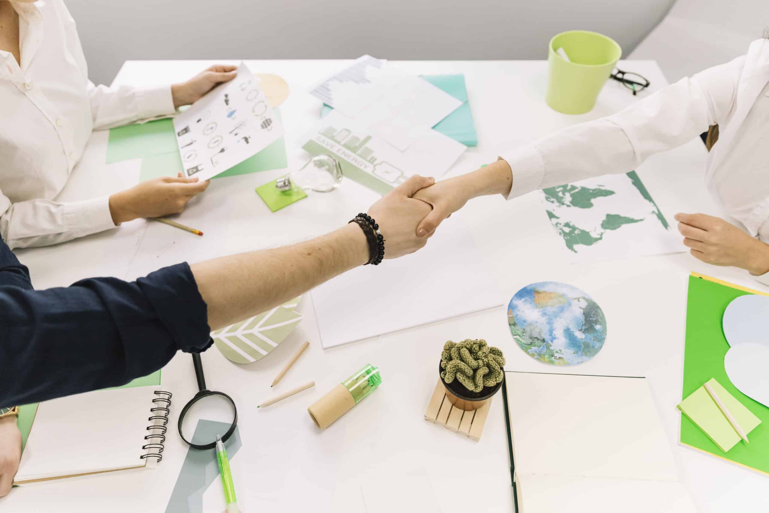 businessman-shaking-hands-with-his-partner-desk